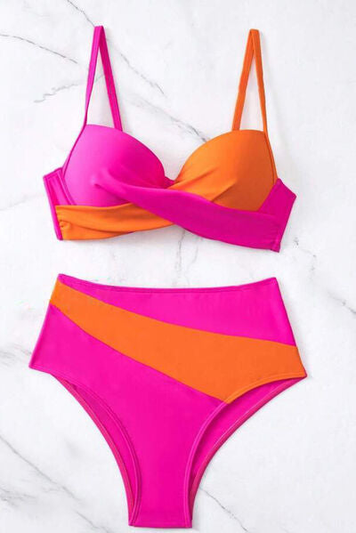 A vibrant pink and orange contrast sweetheart neck bikini set with a two-piece design, high-waisted bottom, and removable padding, on a white marble background.